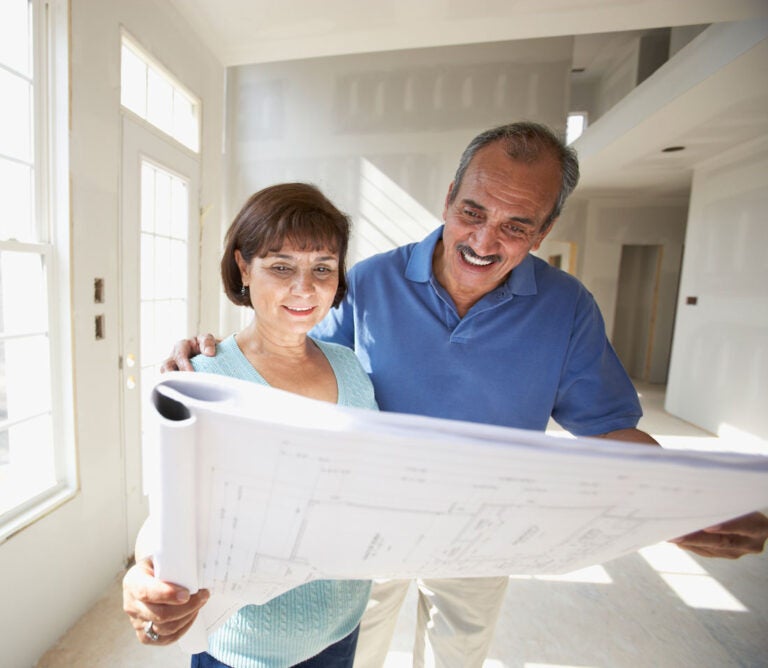 A couple reviews the plans for their reverse mortgage ADU