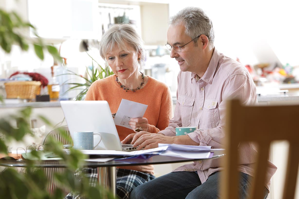 Couple at computer saving for retirement