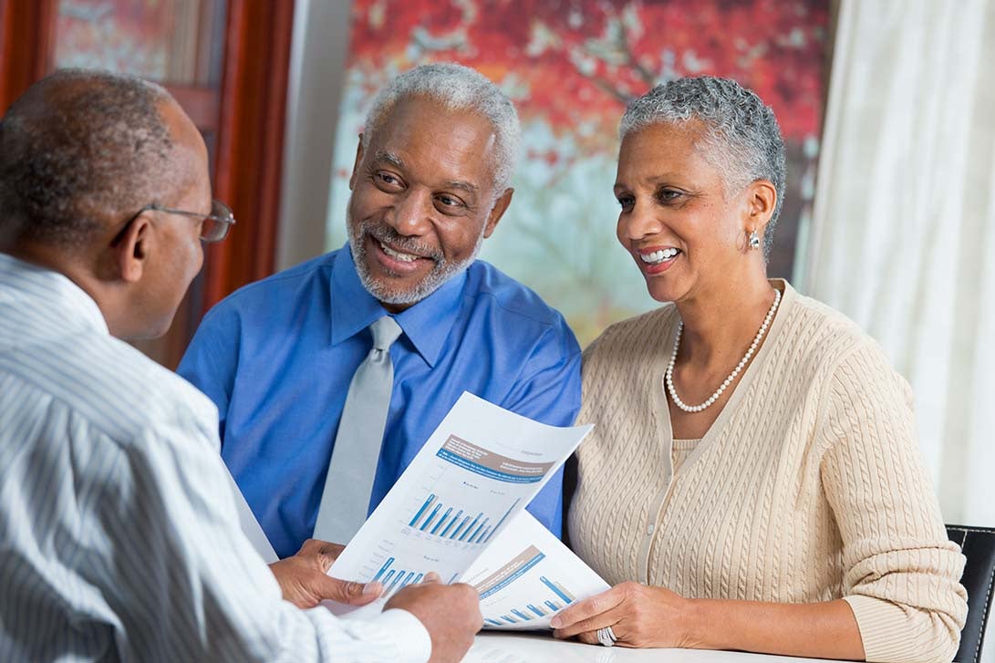 Couple speaking with a financial advisor about retirement