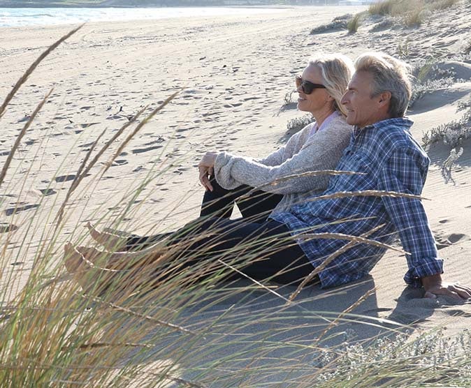 A couple in early retirement enjoying the beach