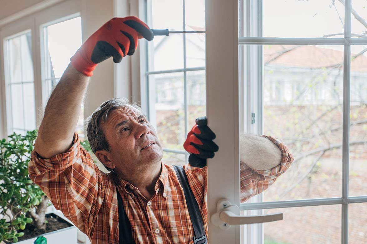 Man using home improvement tips to upgrade a door in his home