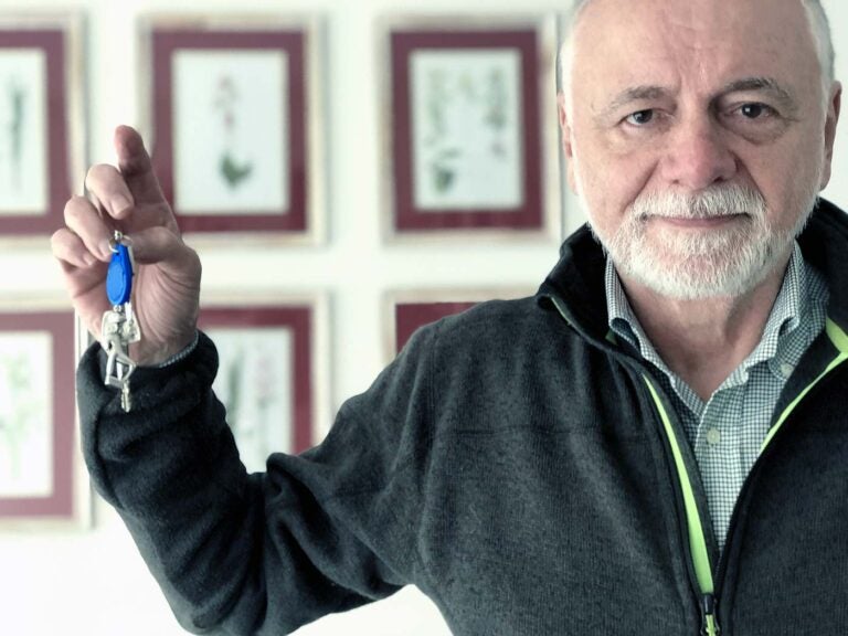 Man holding the key to his home