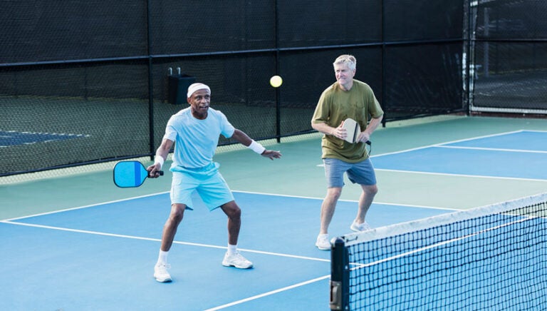 Two friends playing pickleball.