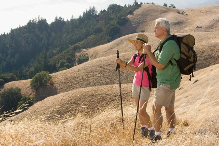 A senior couple hiking safetly