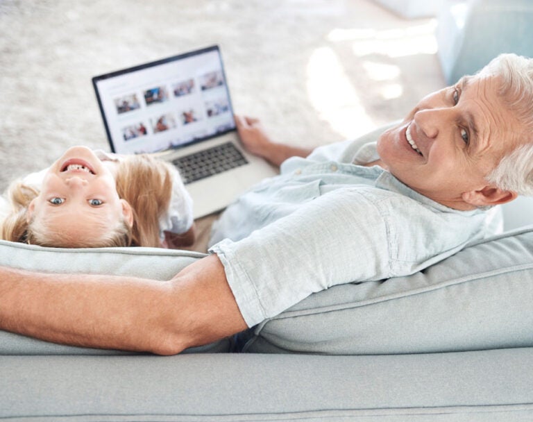 A grandfather sharing digital assets with his granddaughter