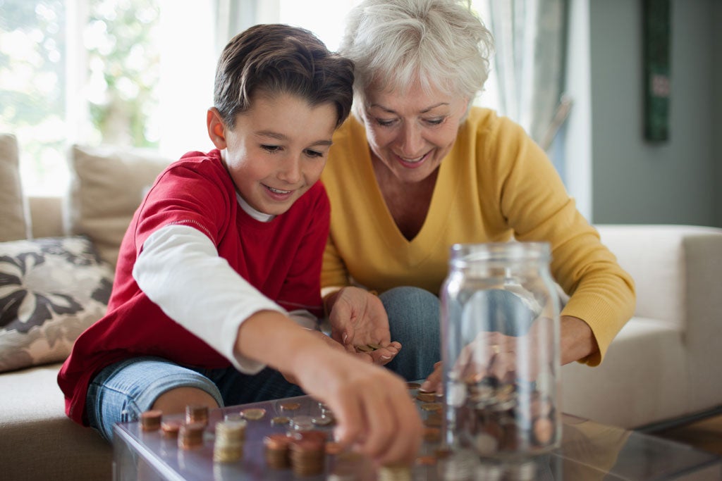 A grandma saves pennies with her grandson and thinks about compounding interest in retirement