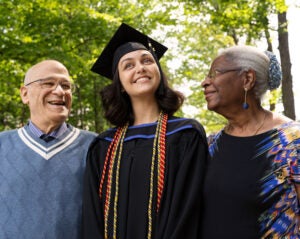 Grandparents who funded their grandchild's education with a reverse mortgage look at her proudly on graduation day
