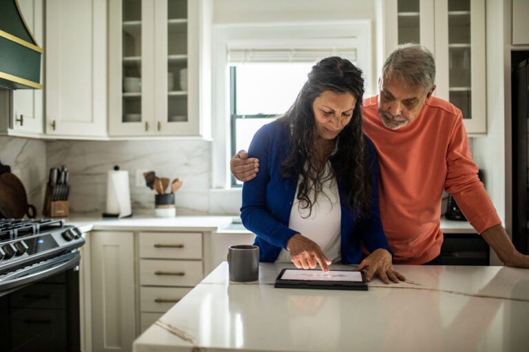 A couple in their home considers their finances