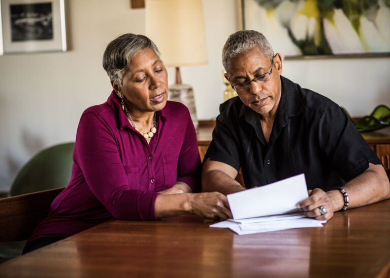 A couple studying how a reverse mortgage works