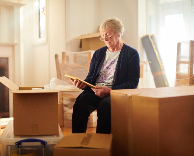 A woman who avoided probate court sits among moving boxes