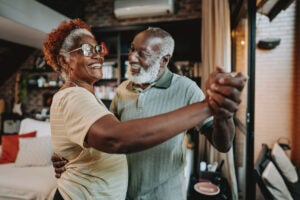 A couple celebrates their reverse mortgage proceeds options.|A woman gathers facts about reverse mortgages