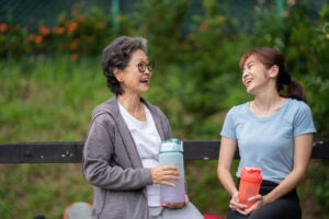 A retirement age woman gives retirement advice to a Gen Z woman