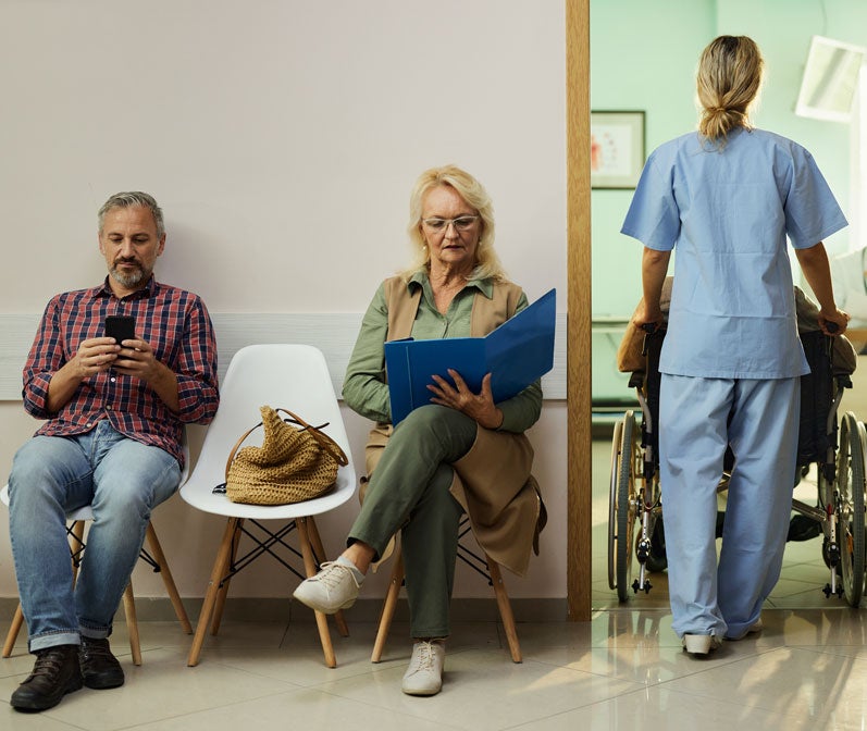 People sit in a doctor's waiting room and learn more about their short-term insurance plan coverage