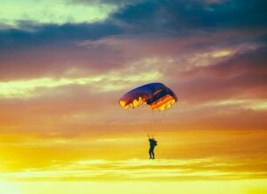 a skydiver at sunset